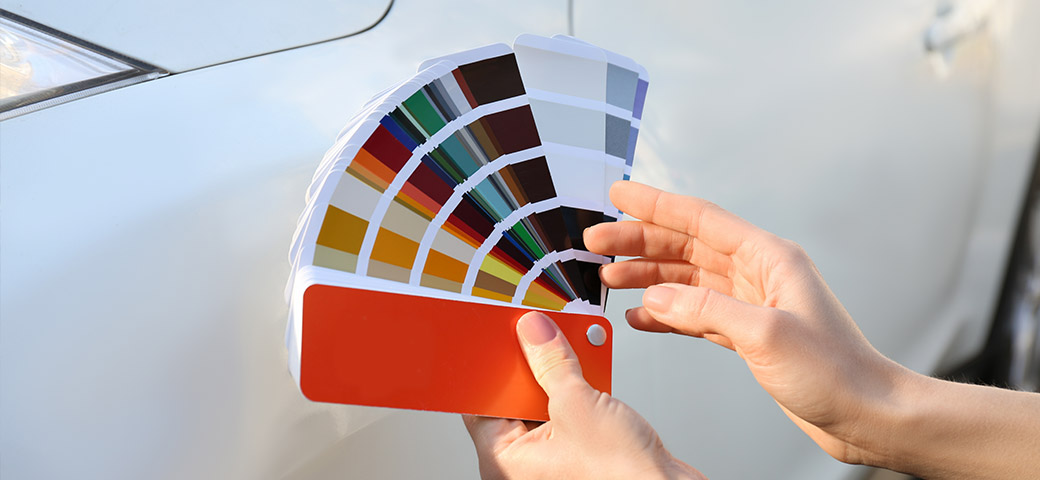 Hands holding a fan of colour samples
