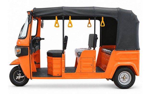 Side view of an orange passenger tuk tuk with bench seats and a black canopy
