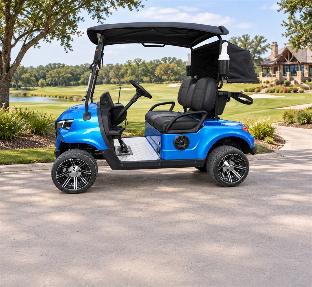 Blue two-seat electric golf cart beside a landscaped path